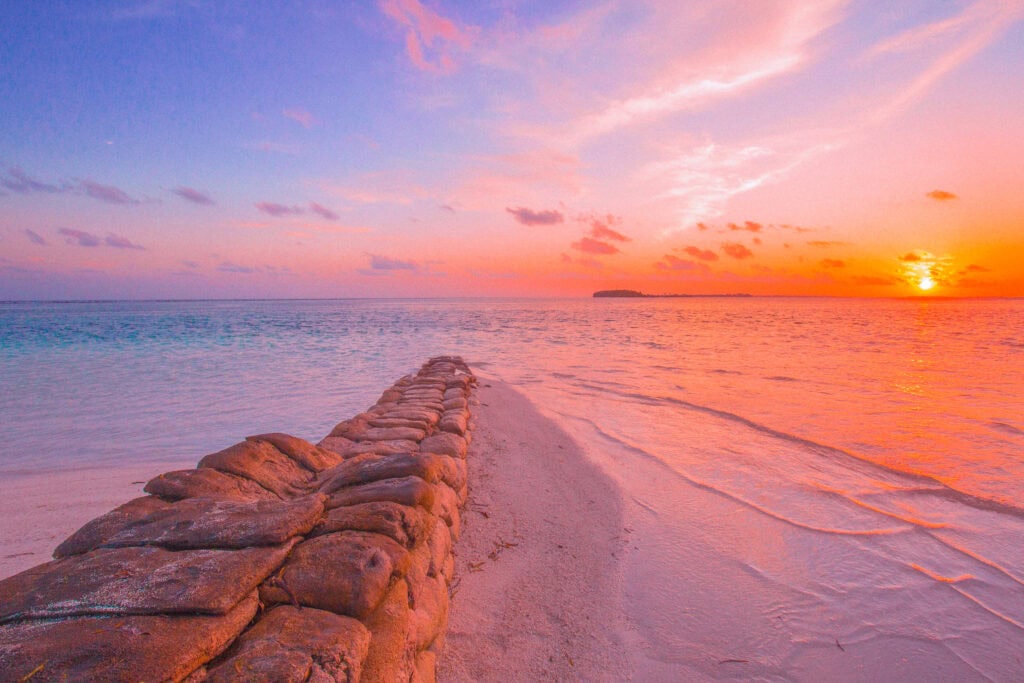 Stunning colorful sunset over the ocean on a luxury Maldives retreat